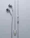 USB-C chrome wired earbuds laid flat, chrome inline volume control and brushed USB-C connector