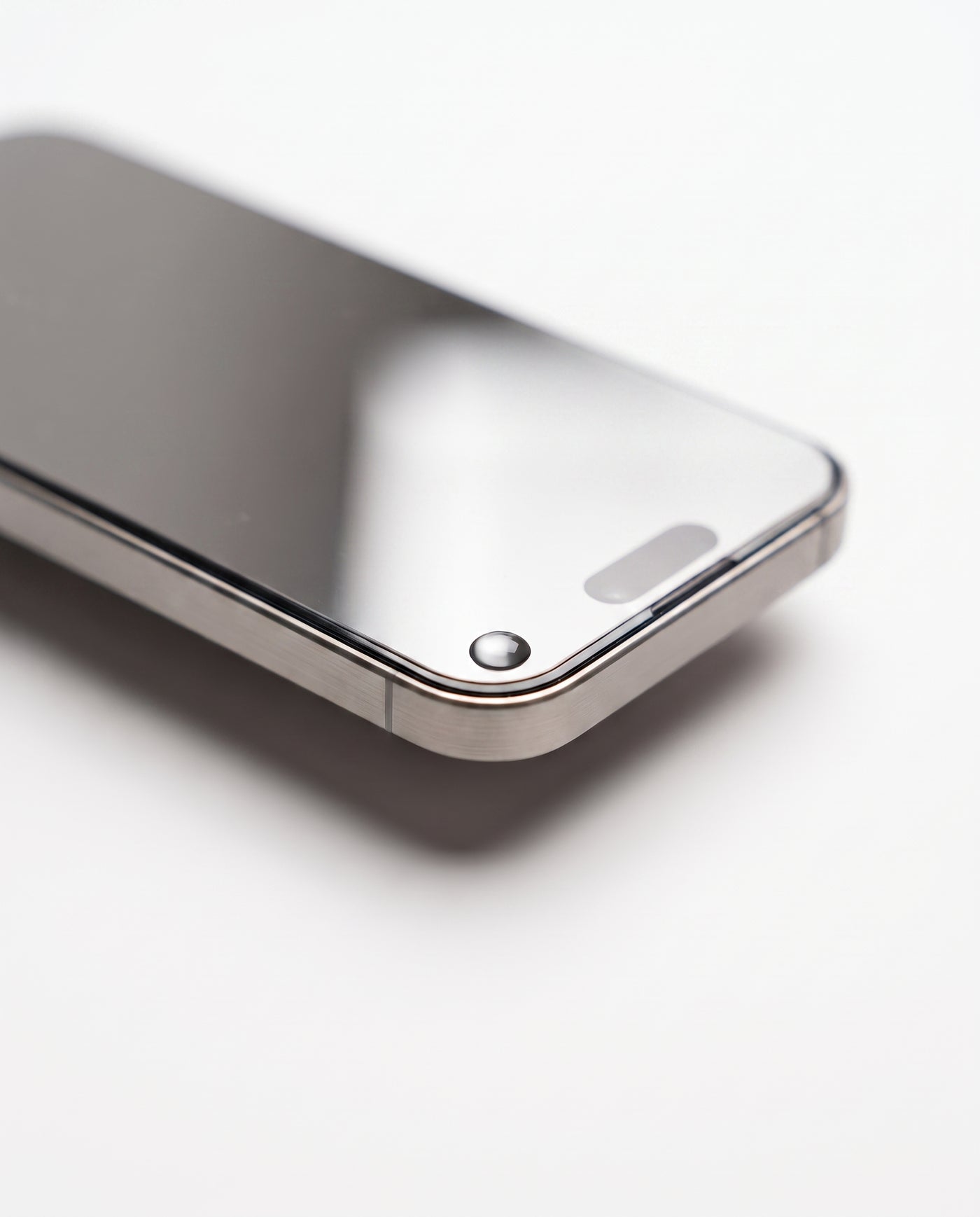 Silver | Macro — protector edge, polished 2.5D edge, water bead, silver tint at an angle
